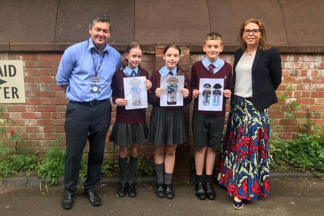 William Alvey School headteacher, Stephen Tapley and Affinity's Alex Davison and pupils holding some of their Imp designs. EMN-210618-123635001