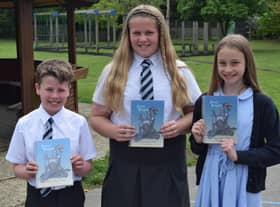 Pupils with their copy of Seven Knights. EMN-210617-132104001