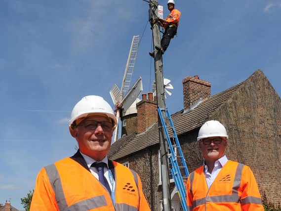 (L-R) Coun Paul Skinner (left), Leader of Boston Borough Council and Dave Axam, Chief Operating Officer at Lightspeed Broadband celebrating the progress of Lightspeed Broadband's network build in front of Maud Foster Mill in Boston.