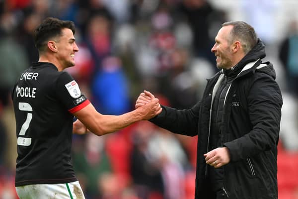 SUNDERLAND, ENGLAND - MAY 22: Michael Appleton Manager of Lincoln congratulates Regan Poole (l) after the Sky Bet League One Play-off Semi Final 2nd Leg match between Sunderland and Lincoln City  at Stadium of Light on May 22, 2021 in Sunderland, England. (Photo by Stu Forster/Getty Images) 775653777