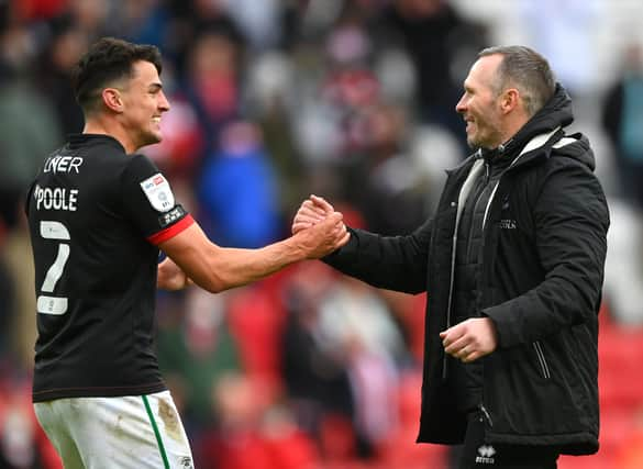 SUNDERLAND, ENGLAND - MAY 22: Michael Appleton Manager of Lincoln congratulates Regan Poole (l) after the Sky Bet League One Play-off Semi Final 2nd Leg match between Sunderland and Lincoln City  at Stadium of Light on May 22, 2021 in Sunderland, England. (Photo by Stu Forster/Getty Images) 775653777