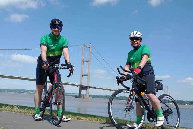Nigel Johnson and Dean Marratty reach the Humber Bridge on their triathlon challenge. EMN-210625-173432001