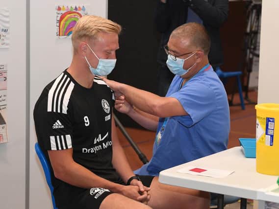 Jonathan Van-Tam vaccinating Jordan Burrow of Boston United