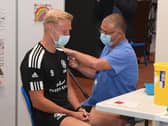 Jonathan Van-Tam vaccinating Jordan Burrow of Boston United