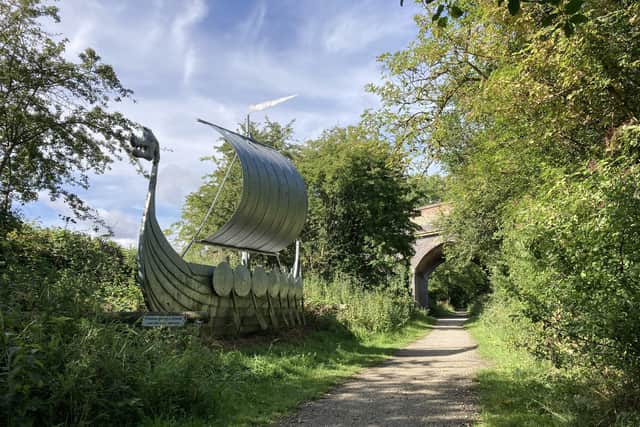 Walkers and cyclists on the Spa Trail can still travel under Martin Bridge on the old railway, where a sculpture of a Viking long ship reflects the area’s ancient history. EMN-210625-135638001
