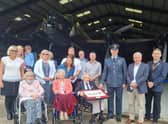 Fred Pearce (centre) celebrating his 100th birthday in the shadow of the Lancaster with 207 Squadron Wing Commander Scott Williams (right) , of RAF Marham, family and friends.