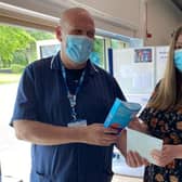 Terry Vine (left ), Clinical and Operational Lead for the Lincolnshire Showground Mass Vaccination Centre, presents chocolates to the recipient of the 100,000th vaccination. EMN-210628-144308001