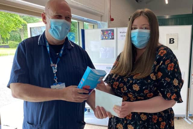 Terry Vine (left ), Clinical and Operational Lead for the Lincolnshire Showground Mass Vaccination Centre, presents chocolates to the recipient of the 100,000th vaccination. EMN-210628-144308001