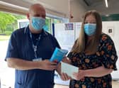Terry Vine (left ), Clinical and Operational Lead for the Lincolnshire Showground Mass Vaccination Centre, presents chocolates to the recipient of the 100,000th vaccination. EMN-210628-144308001
