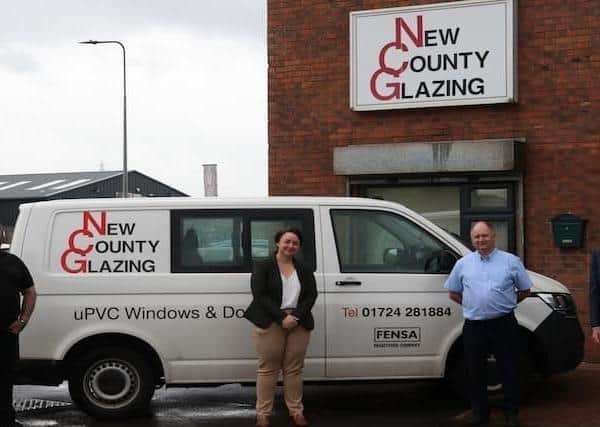 The New County Glazing premises and features from left to right: John Carolan Junior, Scunthorpe MP Holly Mumby-Croft, John Carolan Senior and Councillor Rob Waltham.