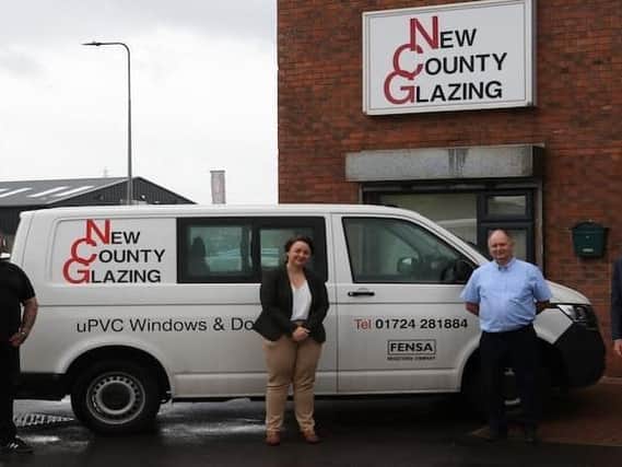 The New County Glazing premises and features from left to right: John Carolan Junior, Scunthorpe MP Holly Mumby-Croft, John Carolan Senior and Councillor Rob Waltham.