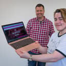 Charity founder Damien Reynolds (back) and employee Alex Inkley (front) with a Wolfpack project laptop