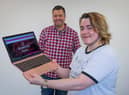 Charity founder Damien Reynolds (back) and employee Alex Inkley (front) with a Wolfpack project laptop