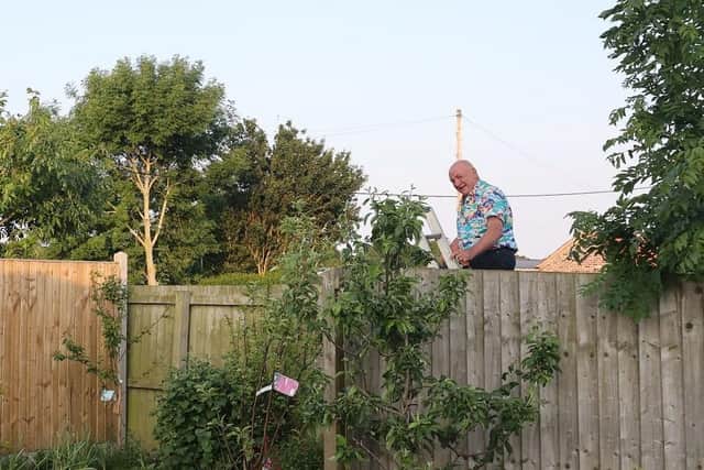 Councillor Matthews used a ladder to climb over the fence to access the parcel of land - which he claims to own.