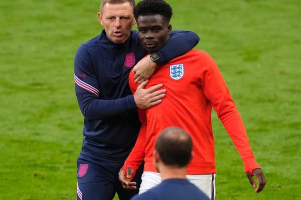 Graeme Jones with Bukayo Saka. Photo: Getty Images
