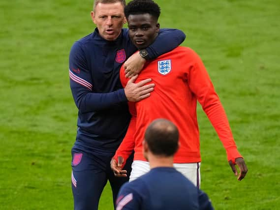 Graeme Jones with Bukayo Saka. Photo: Getty Images