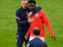 Graeme Jones with Bukayo Saka. Photo: Getty Images
