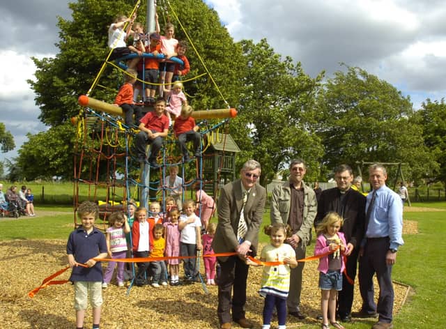 Coun Peter Bedford officially opening the new play equipment in Freiston 10 years ago. Pictured holding the ribbon (from left) are Charlie Fairman, seven, Gabriella Bedford, four, Cerys Horrey, seven. Pictured (back, from left) Coun Bedford, John Wright and Alistair Godwin, management committee for playing field association, and the Rev Andrew Higginson.