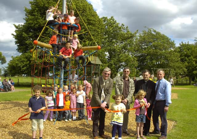 Coun Peter Bedford officially opening the new play equipment in Freiston 10 years ago. Pictured holding the ribbon (from left) are Charlie Fairman, seven, Gabriella Bedford, four, Cerys Horrey, seven. Pictured (back, from left) Coun Bedford, John Wright and Alistair Godwin, management committee for playing field association, and the Rev Andrew Higginson.