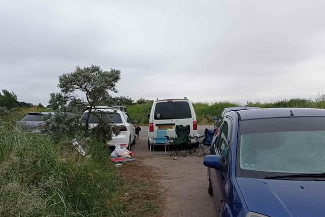 Cars area parking overnight in Princes Car Park, leaving litter and causing concern for passing dog walkers.
