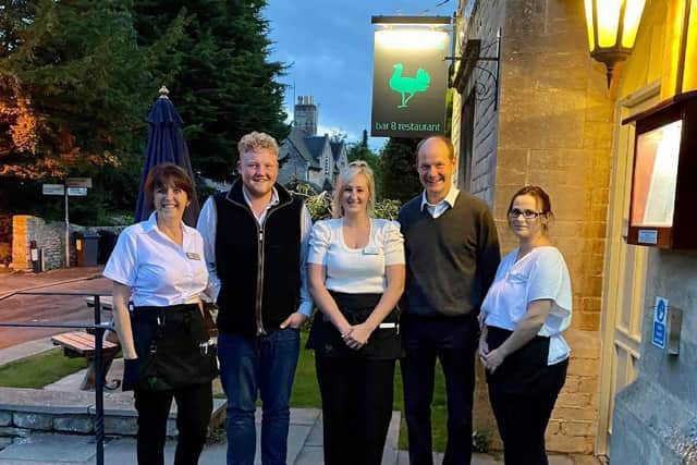 Kaleb Cooper and Charlie Ireland from Clarkson's Farm pictured with staff and owner Lesley Lonsdale (left) at The Bustard Inn in Rauceby. EMN-210607-124029001