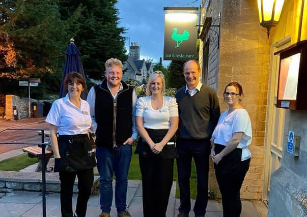 Kaleb Cooper and Charlie Ireland from Clarkson's Farm pictured with staff and owner Lesley Lonsdale (left) at The Bustard Inn in Rauceby. EMN-210607-124029001