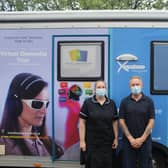 Staff members Emma Kew and Dean Bunch prepare to enter the Virtual Dementia Bus.