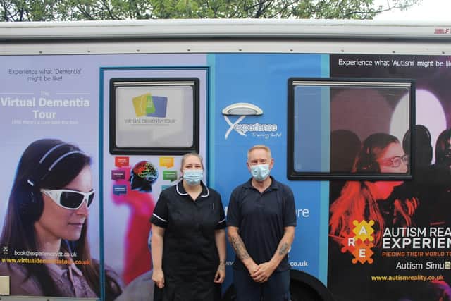 Staff members Emma Kew and Dean Bunch prepare to enter the Virtual Dementia Bus.