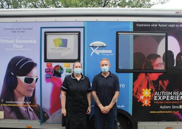 Staff members Emma Kew and Dean Bunch prepare to enter the Virtual Dementia Bus.