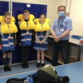 AEA (Aircrew Equipment Assemblies) Supervisor, Chris Wade (right) with pupils Lucas Frost, Ella Jenkins, Luke Papworth and Vania Rodriguez. Photo: Affinity Flying Services EMN-210807-114556001
