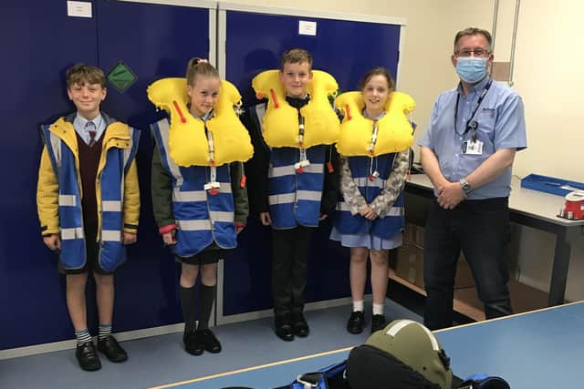 AEA (Aircrew Equipment Assemblies) Supervisor, Chris Wade (right) with pupils Lucas Frost, Ella Jenkins, Luke Papworth and Vania Rodriguez. Photo: Affinity Flying Services EMN-210807-114556001