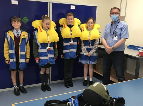 AEA (Aircrew Equipment Assemblies) Supervisor, Chris Wade (right) with pupils Lucas Frost, Ella Jenkins, Luke Papworth and Vania Rodriguez. Photo: Affinity Flying Services EMN-210807-114556001