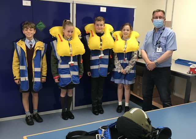 AEA (Aircrew Equipment Assemblies) Supervisor, Chris Wade (right) with pupils Lucas Frost, Ella Jenkins, Luke Papworth and Vania Rodriguez. Photo: Affinity Flying Services EMN-210807-114556001