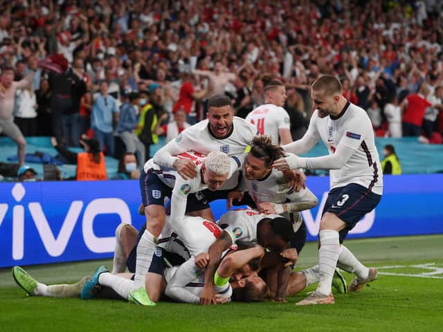 Matchwinner Kane is mobbed. Photo: Getty Images
