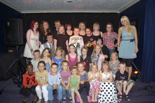 Members of The Biz Theatre School, with theatre school leader Sam Sillett (right).