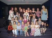 Members of The Biz Theatre School, with theatre school leader Sam Sillett (right).