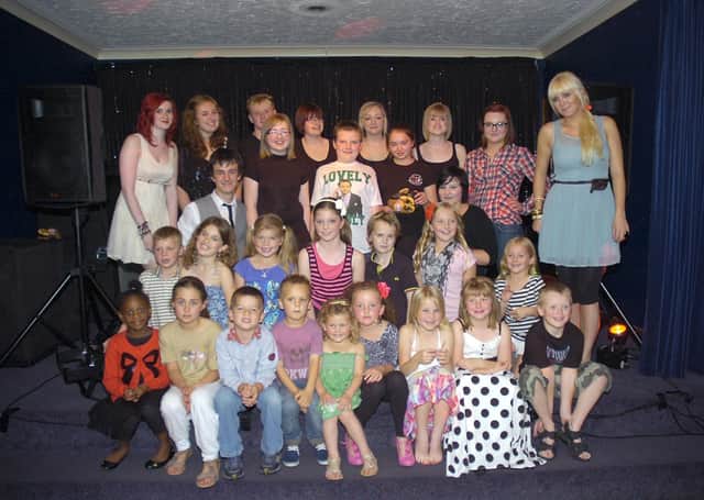 Members of The Biz Theatre School, with theatre school leader Sam Sillett (right).