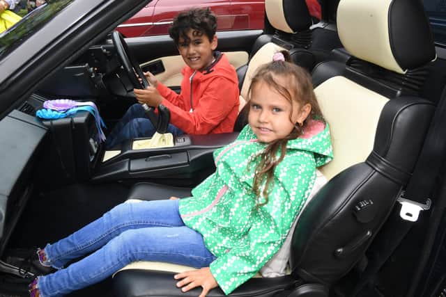 Shiloh Amas 7 and Lottie-Blossom Amos 5 of Boston sitting in a Toyota MR2 EMN-210907-072143005