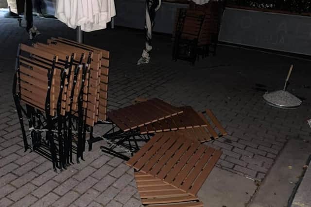 Damaged tables and chairs outside Tiamo Italian restaurant. EMN-211207-133010001