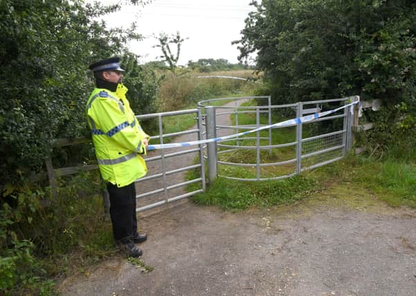 Police incident on Mareham Pastures, Sleaford. Officers stand guard at the gateway from Lavender Close.. EMN-211207-114535001
