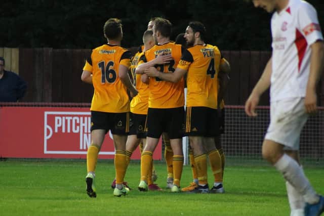 The matchwinner is mobbed by teammates. Photo: Oliver Atkin
