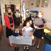 Receiving the ?15,000 towards the new library for Cranwell School. From left - PTA chairman Eleanor Ward, RBL chairman Major Clive Candlin, Standard bearer Brian Harvey, KS2 english leader Fiona Birchenall and pupils Finlay case, aged five, and Tilly Case, seven. EMN-210719-122613001