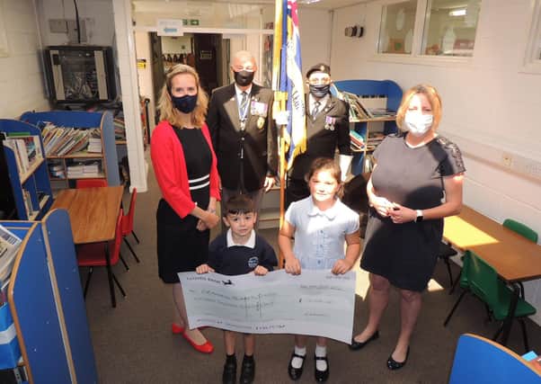 Receiving the ?15,000 towards the new library for Cranwell School. From left - PTA chairman Eleanor Ward, RBL chairman Major Clive Candlin, Standard bearer Brian Harvey, KS2 english leader Fiona Birchenall and pupils Finlay case, aged five, and Tilly Case, seven. EMN-210719-122613001