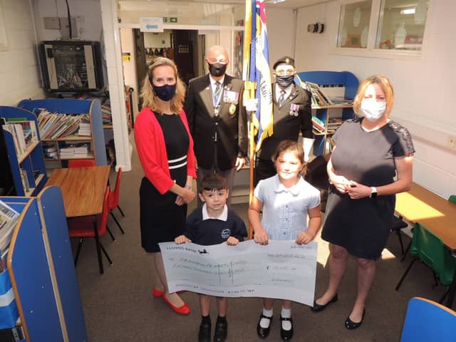 Receiving the ?15,000 towards the new library for Cranwell School. From left - PTA chairman Eleanor Ward, RBL chairman Major Clive Candlin, Standard bearer Brian Harvey, KS2 english leader Fiona Birchenall and pupils Finlay case, aged five, and Tilly Case, seven. EMN-210719-122613001