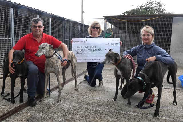 Sue Spencer of Helpringham raised ?1500 for the rescue centre in Fosdyke by walking 100 miles. L-R Vaughan Harman of Bob and Hope rescue centre, Sue Spencer and Santa Drozdova - volunteer. Pictured with rescue dogs L-R Jim, Billy, Noir and Mario. EMN-210807-094322001
