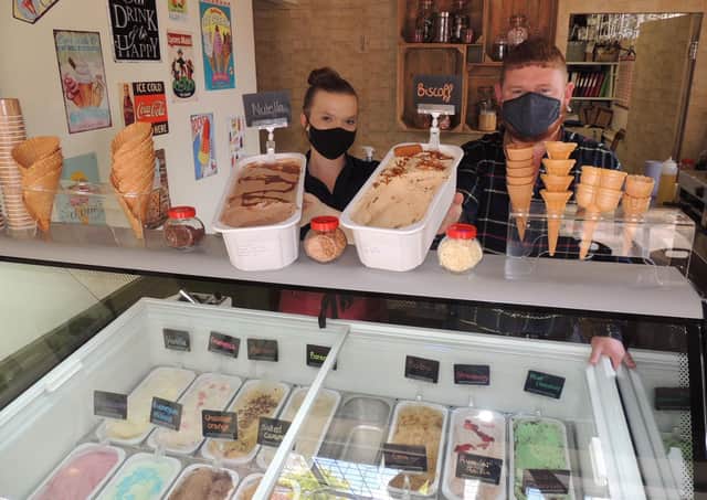 David Smith with staff member Ria Gourves at the Finch Miller Ice Cream shop. EMN-210719-180601001