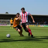 Fraser Preston battles for the ball in the friendly against Lincoln City. Photo: Oliver Atkin