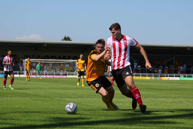 Fraser Preston battles for the ball in the friendly against Lincoln City. Photo: Oliver Atkin