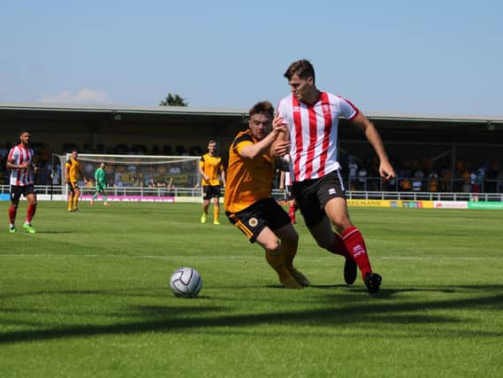 Fraser Preston battles for the ball in the friendly against Lincoln City. Photo: Oliver Atkin