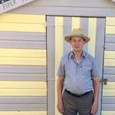 Resident Norman Newton outside one of the beach huts.